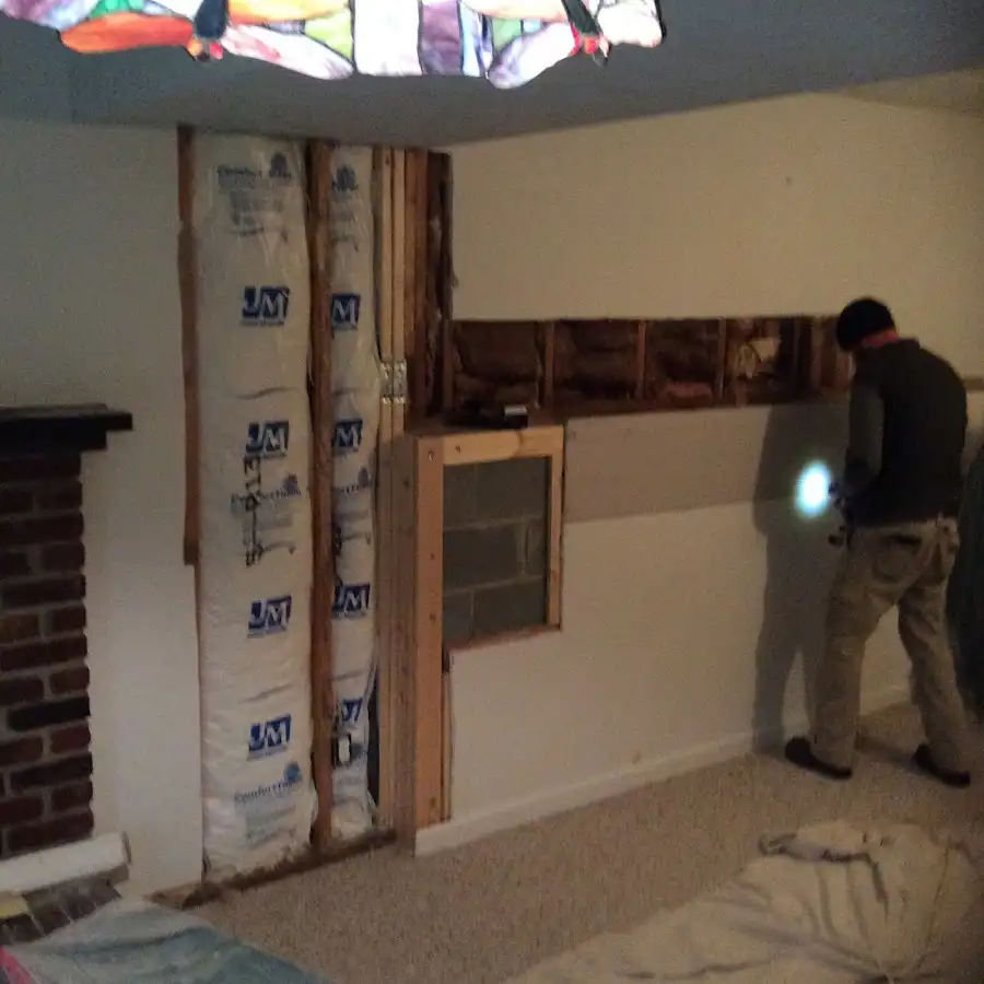 Restoration technician inspecting water damage in Conroe